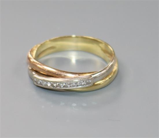 A modern three colour 585 yellow metal and channel set nine stone diamond ring, size L.